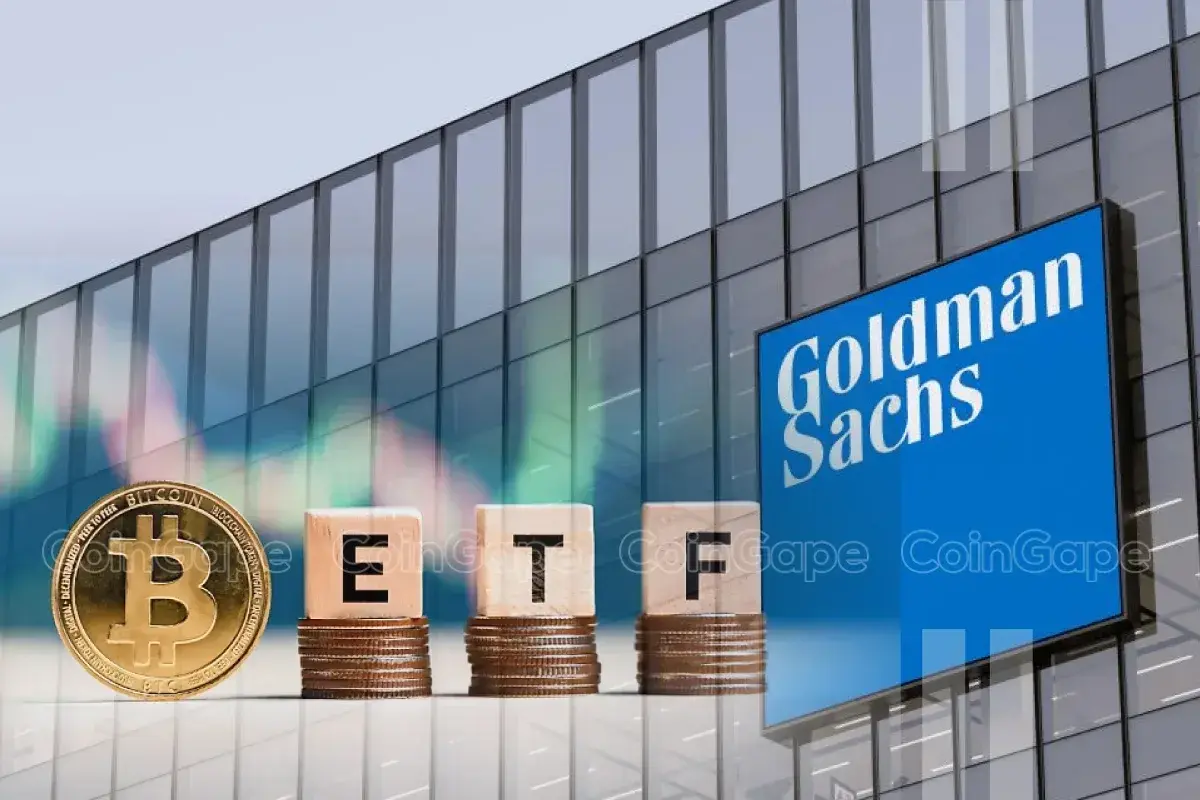 Bitcoin coin next to stacked coins displaying 'ETF' in front of Goldman Sachs building.