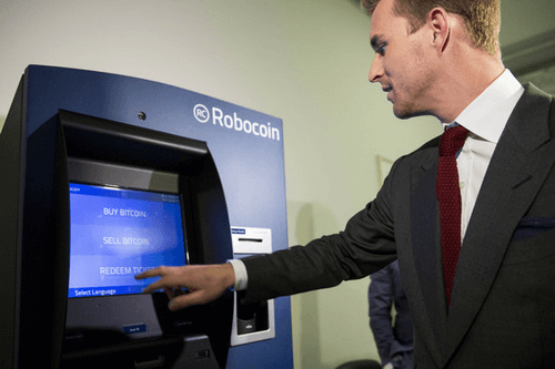 Robocoin CEO and co-founder Jordan Kelley uses the Robocoin Bitcoin ATM, during a demonstration of the ATM in the Rayburn House Office Building on Capitol Hill, April 8, 2014 in Washington. Photo: Robocoin