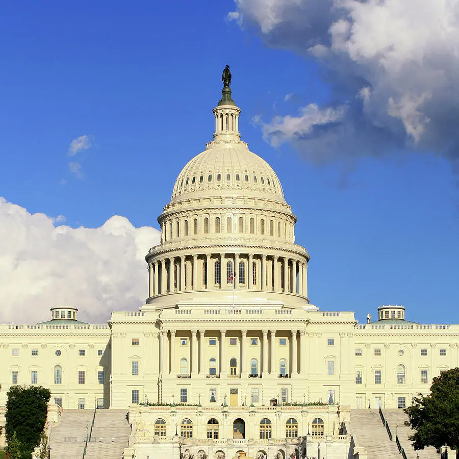 The US Capitol Building with a clear blue sky in the background.